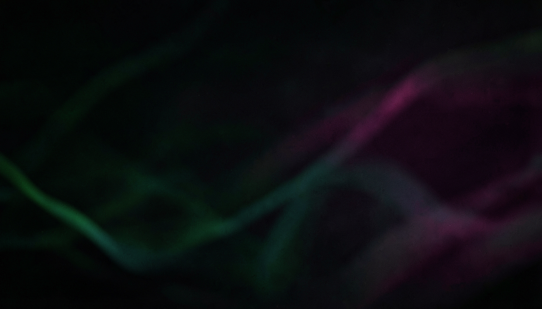 Dark abstract background with subtle green and teal wave patterns, calm and modern tech mood