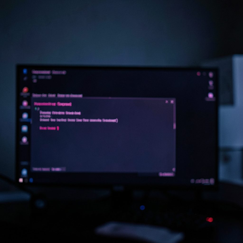 Close-up of a Windows error dialog on a dark screen, moody blue-gray atmosphere with shallow depth of field